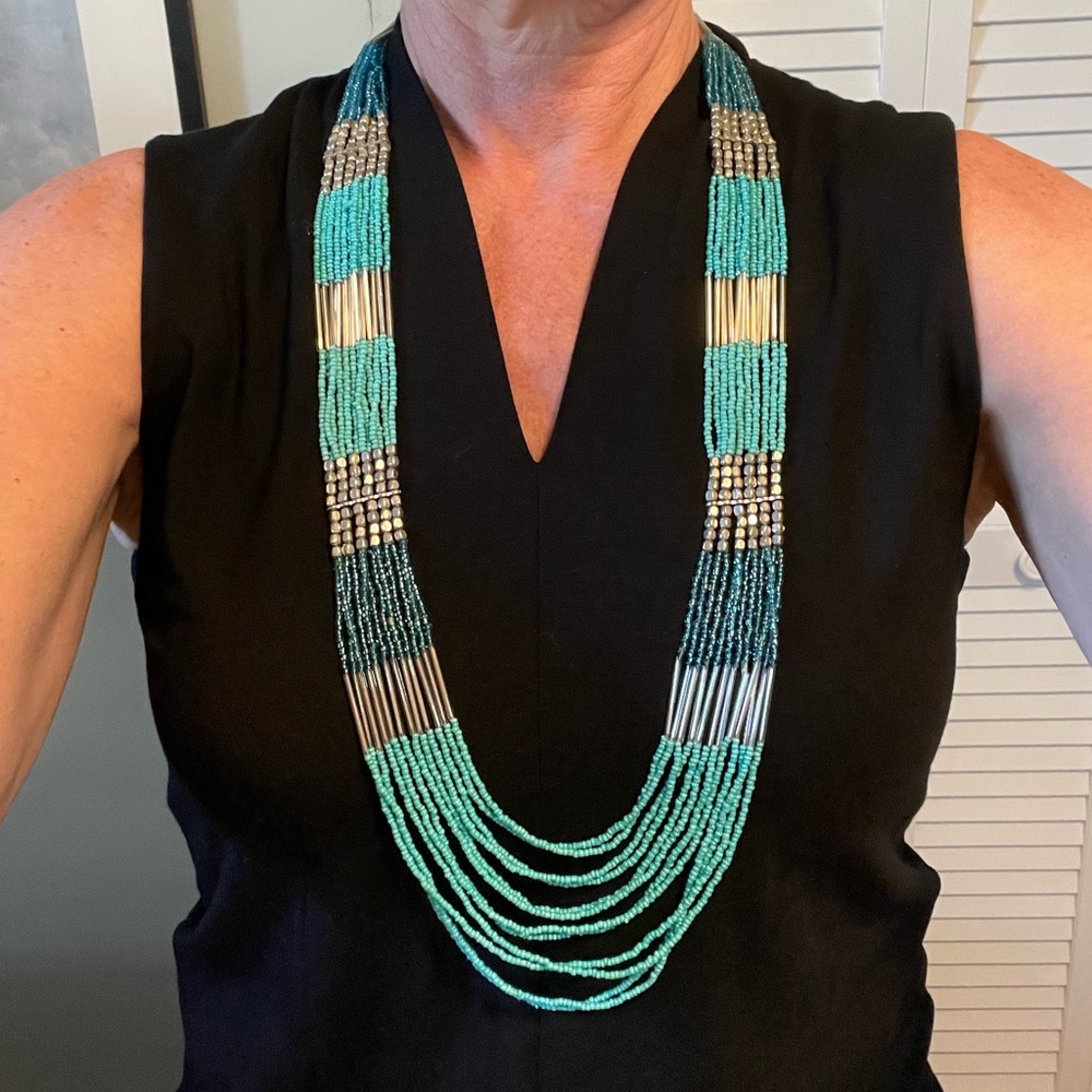 Exquisite multi strand turquoise and silver beaded long necklace.